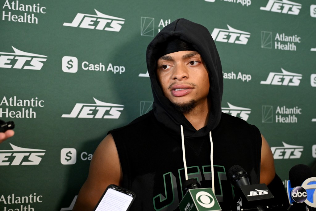 Jets quarterback Justin Fields in a black hoodie speaks to the media. Jets quarterback Justin Fields (7) speaks with the media after practice in Florham Park, NJ.