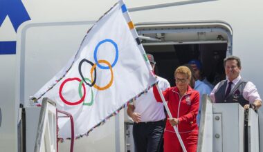 Los Angeles Mayor Karen Bass holds the official Olympic flag at Los Angeles International Airport on Aug. 12, 2024. (AP Photo/Damian Dovarganes)