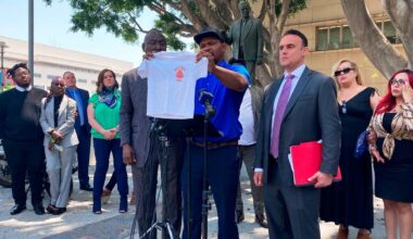 Jonathan Wright, 39, holds up the T-shirt he was given when he first went to MacLaren Children's Center in El Monte as an 8-year-old during a news conference in Los Angeles, June 9, 2022. (AP Photo/Christopher Weber, File)