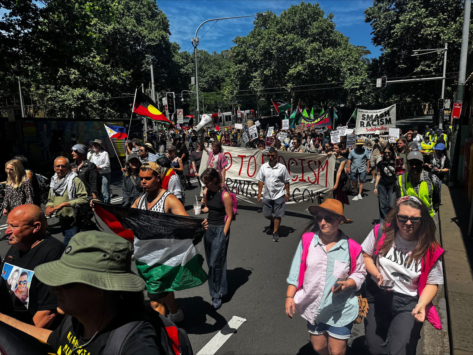 Protesters holding anti-racism banners and signs