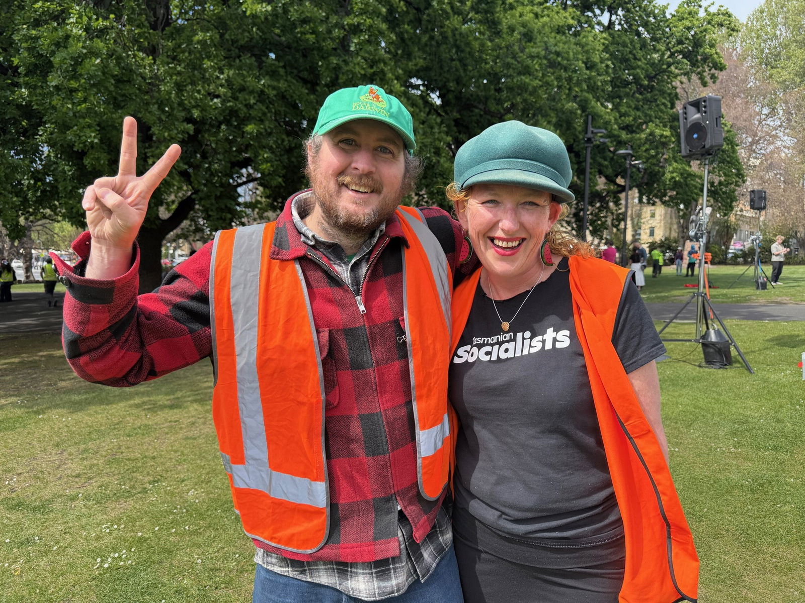 Matt Hauvrick and Angela Finch stand in park land wearing high visibility vests