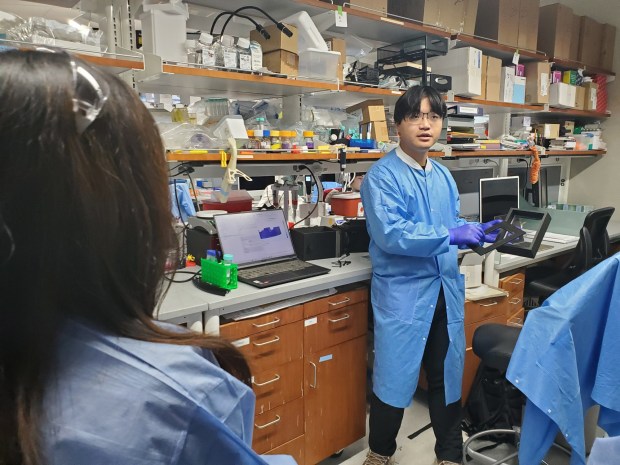 Dennis Zhou discusses the work and equipment of the Sanford Consortium bioengineering bay. (Ashley Mackin-Solomon)