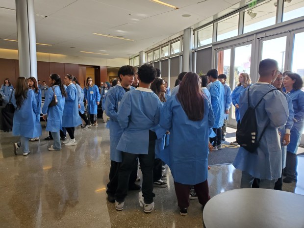 San Diego-area high school students suit up in lab coats for breakout sessions at a Stem Cell Awareness Day symposium at the Sanford Consortium for Regenerative Medicine in La Jolla. (Ashley Mackin-Solomon)