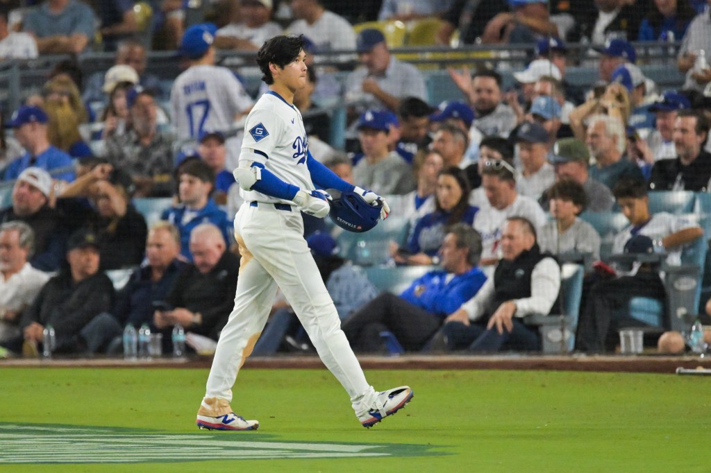 Shohei Ohtani walking off the field after grounding out in a Dodgers game.