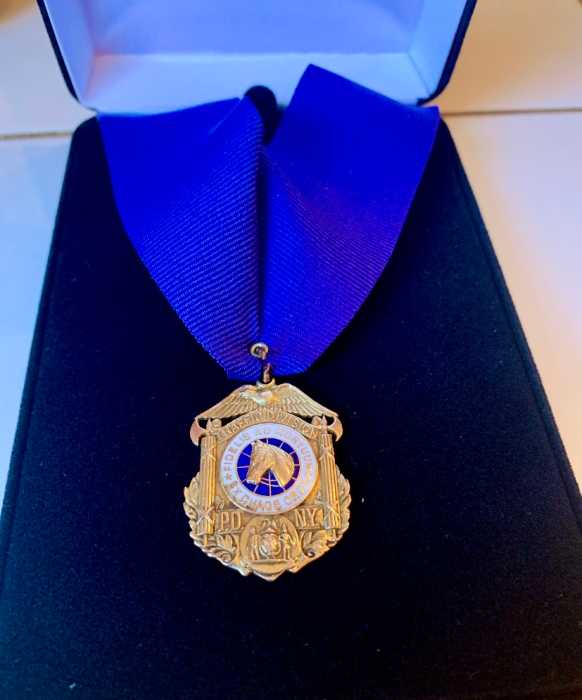 a gold medal on a blue ribbon 