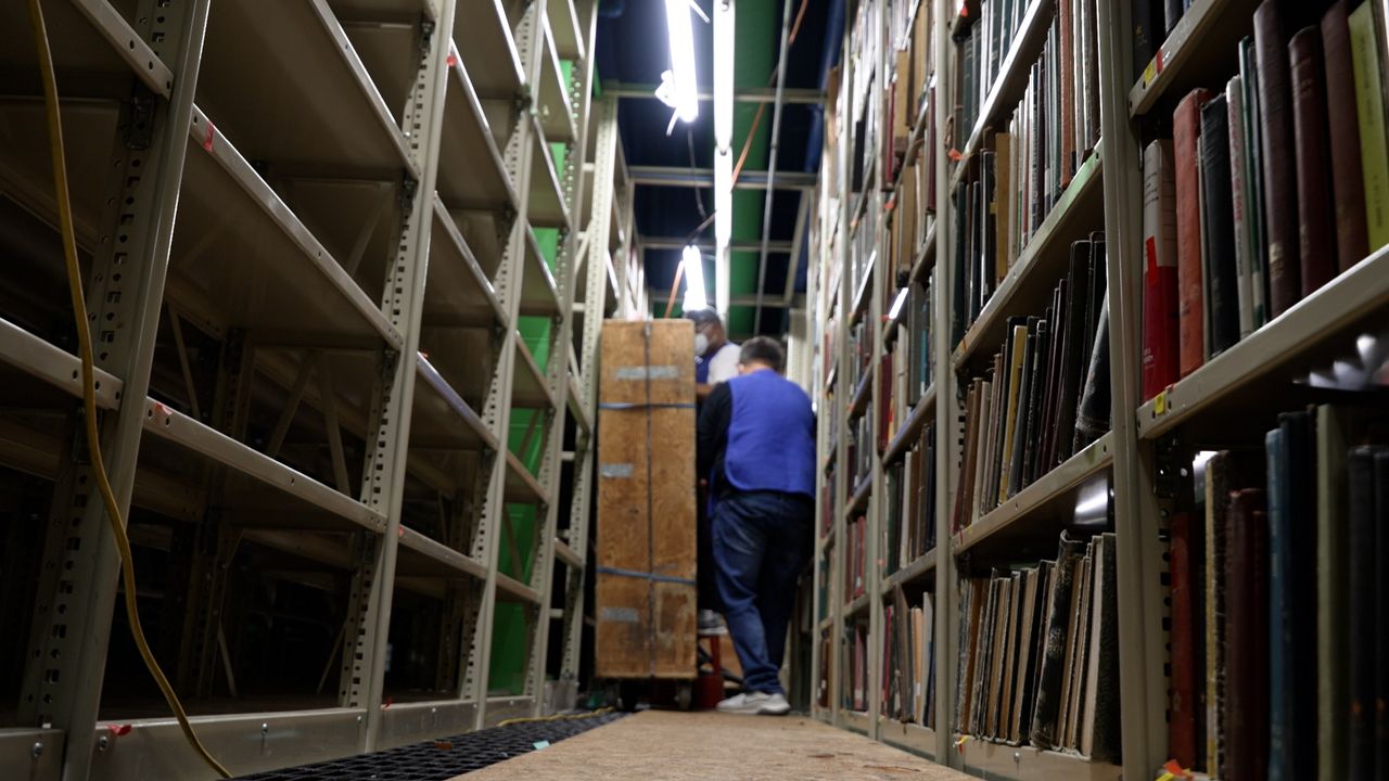 Workers clean books at Cleveland Public Library's Lakeshore Facility