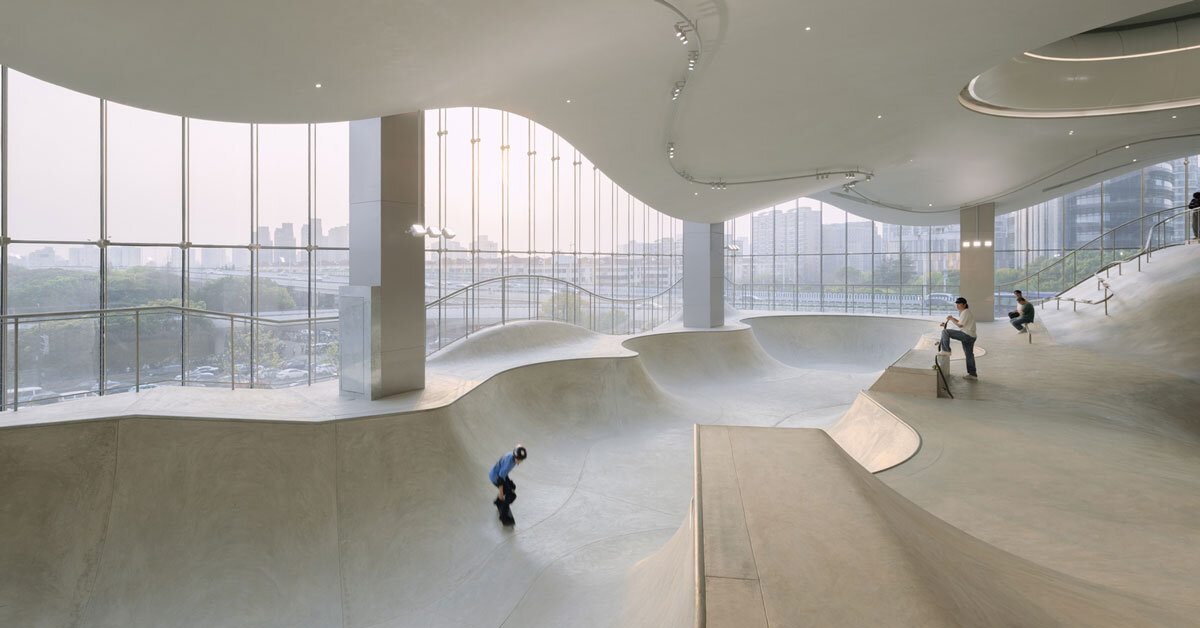 curved urban skatepark in floating glass volume overlooks shanghai’s skyline