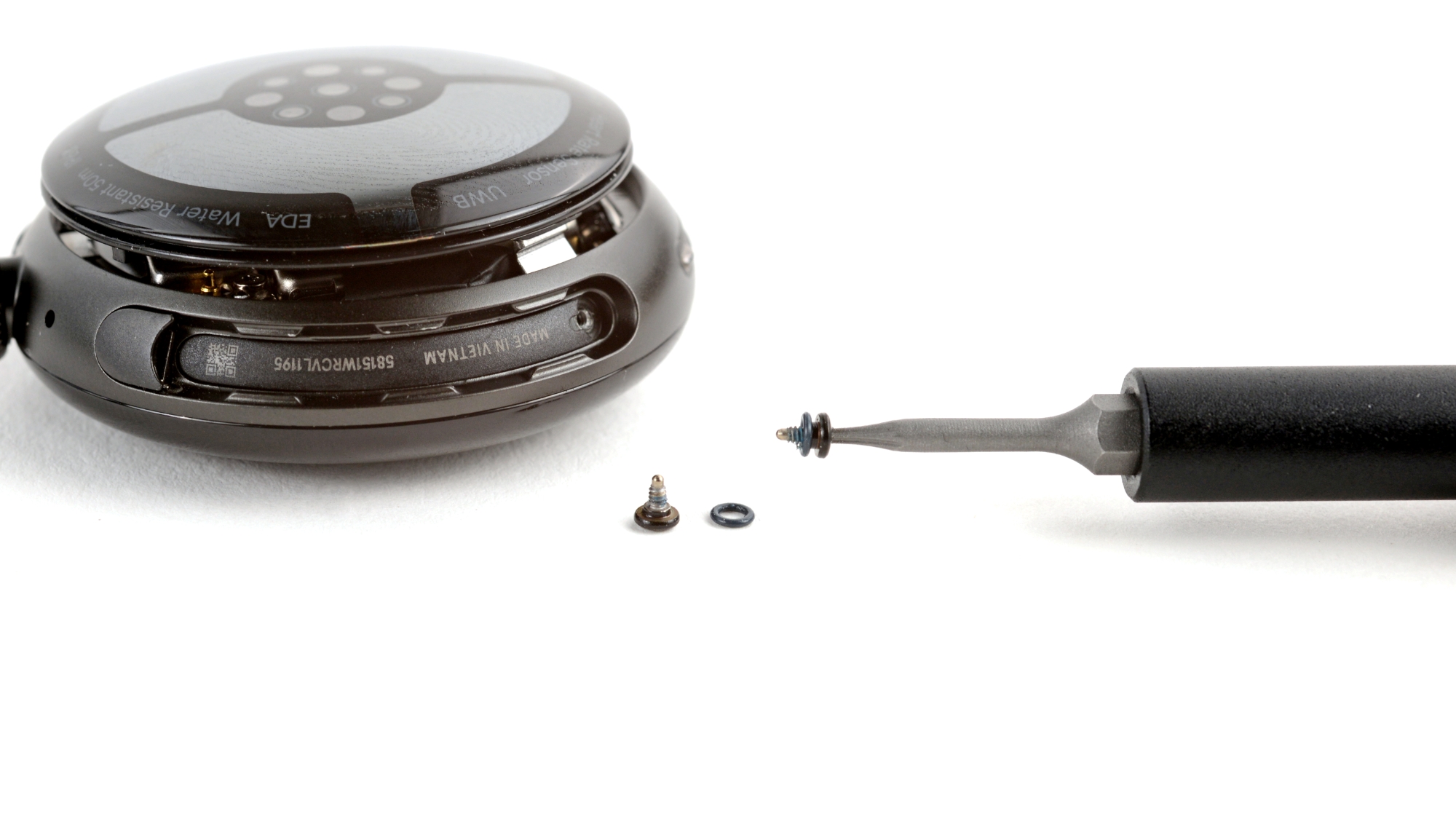 A close up of the Pixel Watch 4 being unscrewed for repairs