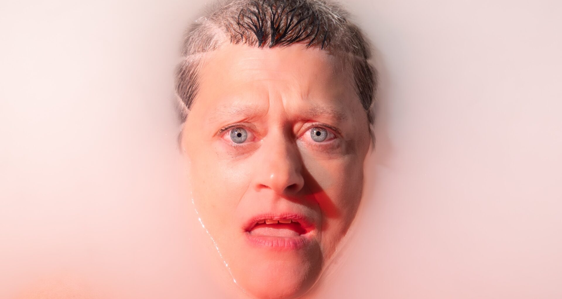 A woman face up in bathwater.