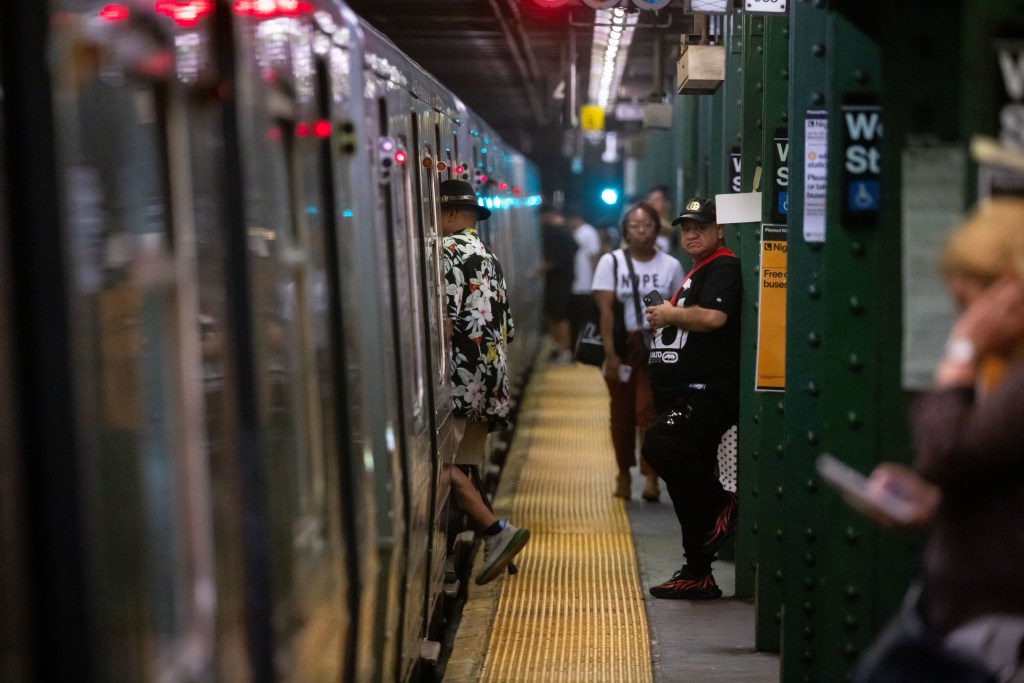 People wait for trains on the B,D,F,M platform at West 4th Street station during subway delays on Wednesday, July 17, 2024 in New York City.