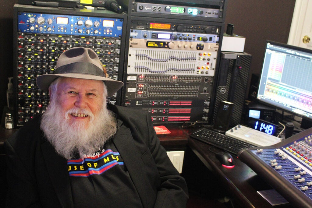 Jamey Reilly, owner of Jamey's House of Music in Lansdowne, sits near a computer inside his shop