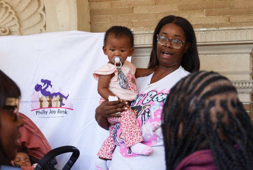 A woman holding a baby