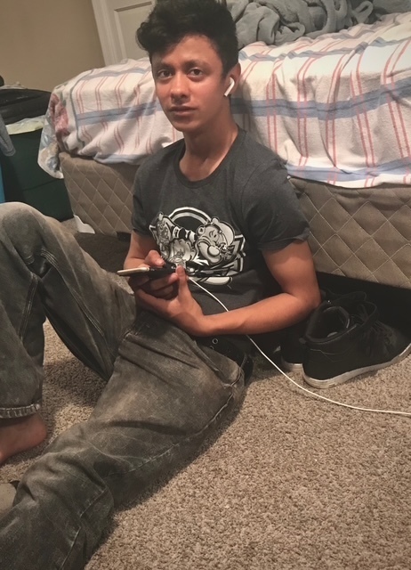 This photo provided by Henry Castro shows Josué Castro Rivera holding a cell phone in Virginia Beach, Va., in April 2021. 