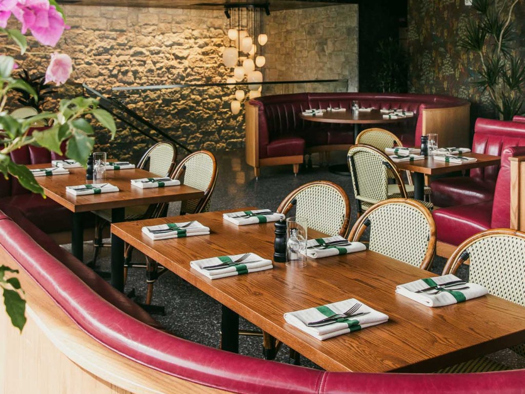 Restaurant dining room with tables and booths.