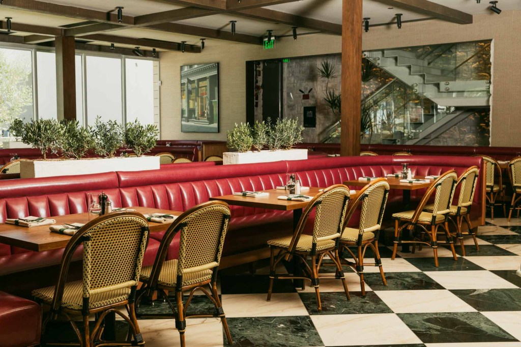 A long booth lined with tables.