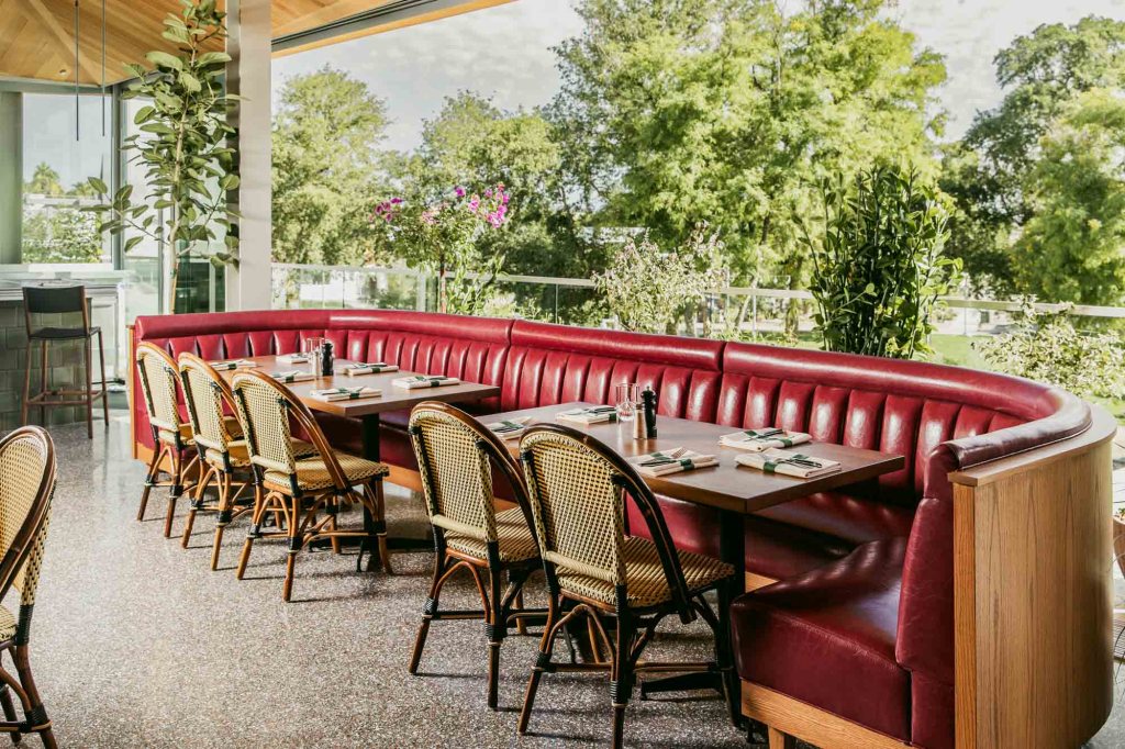 A wraparound booth with a view of a park outside.