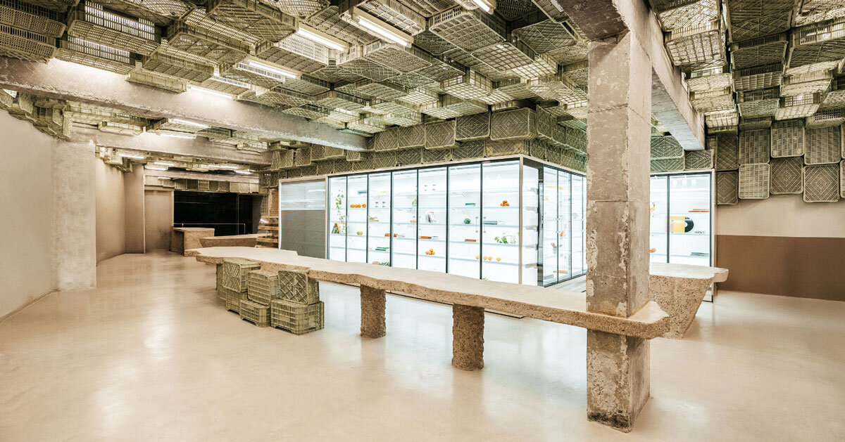 ceiling of recycled plastic crates expands over brutalist supermarket in mallorca