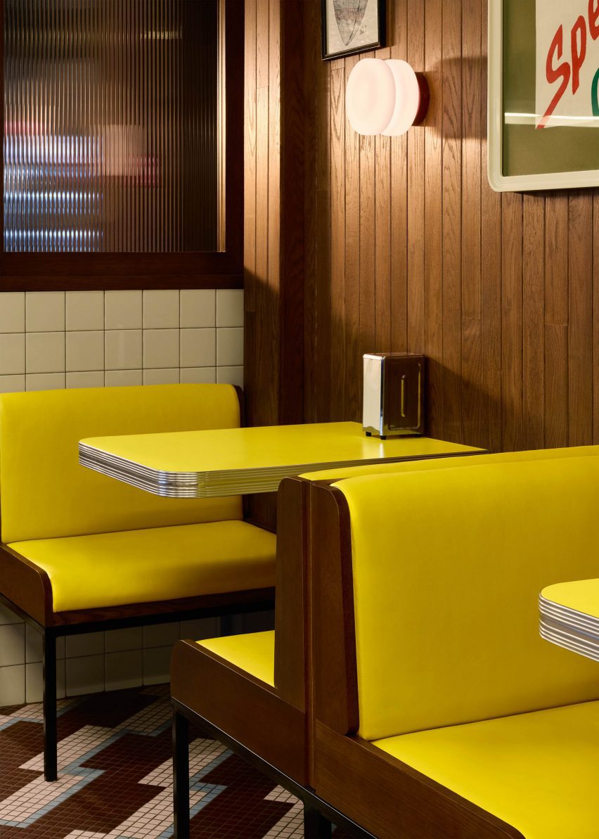 Yellow booth seating with yellow and stainless steel tables