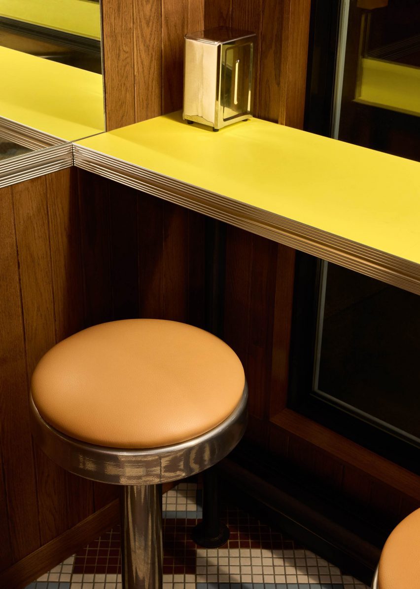 Orange-topped stool beside a yellow counter