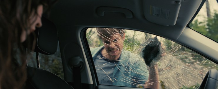Jack Quaid smashing car window in COMPANION