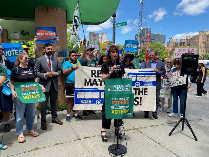 NYC Mayor’s Race: Where the candidates stand on street redesigns, bike and bus lanes, fare evasion and more 2 woman speaking at a podium during a rally for better bus service in Brooklyn