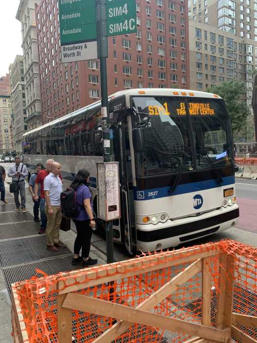 Onward and upward: Staten Islanders report marked improvement in express bus service, but more work still needed 2 a line of people gathers at a bus stop in the rain