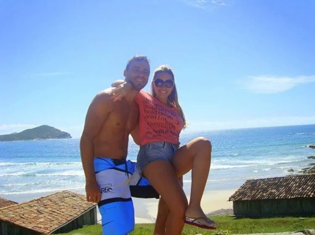 Ana and Jeferson embracing in a photo on a beach in Brazil.