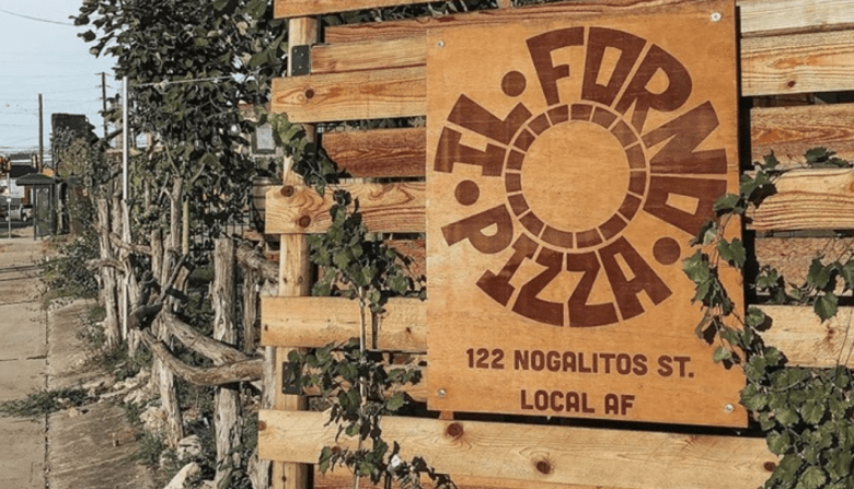 Exterior of Il Forno, displaying its name on a rustic sign.