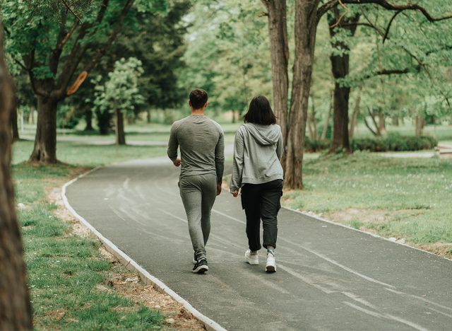 Sport couple walking on the path in the park