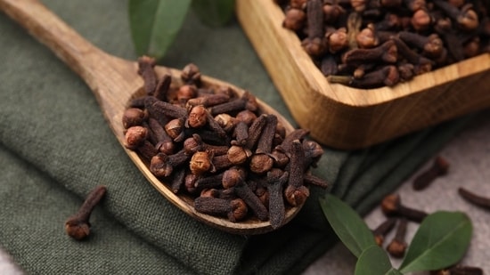 To prepare clove water, simply steep a few cloves in hot water for 10-15 minutes, strain, and drink before bed.(Shutterstock)