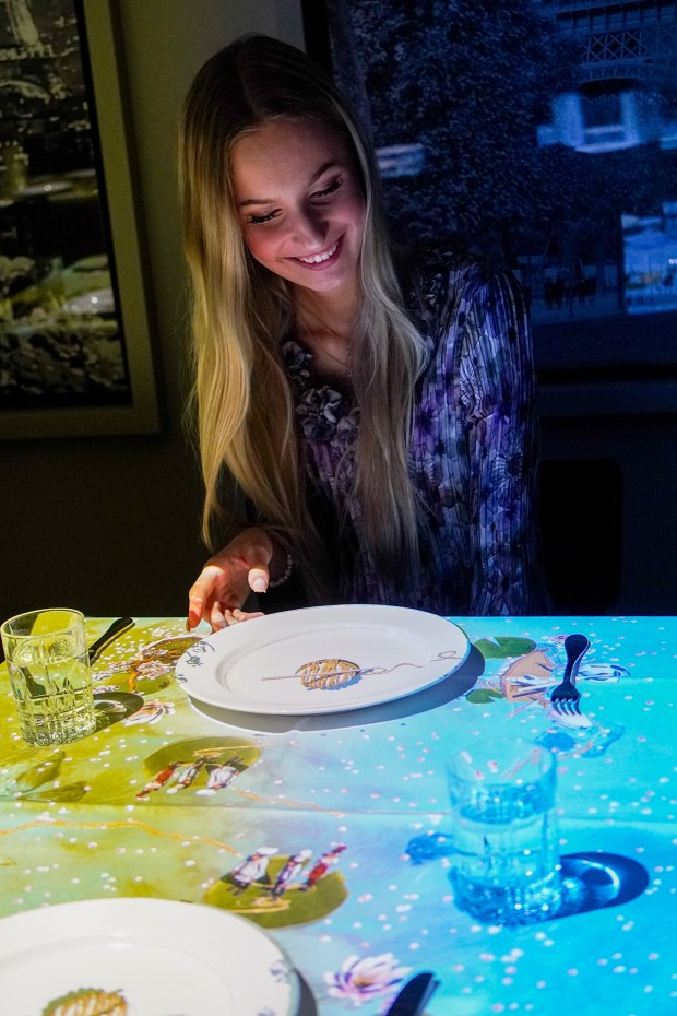 A diner in Japan watches the show during a La Petit Chef dinner in Italy. Hilton San Diego Gaslamp Quarter has installed the technology to introduce Le Petit Chef to San Diego on Nov. 1. (Le Petit Chef)