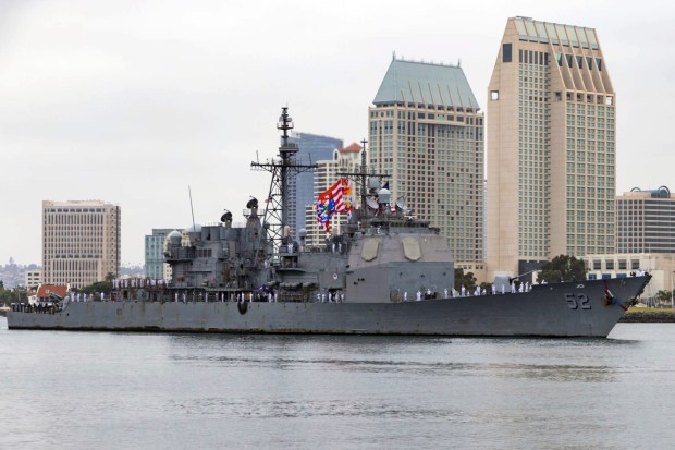 Sailors man the rails as the guided-missile cruiser USS Bunker Hill (CG 52) returns to Naval Base San Diego after a six-month deployment in support of maritime security operations and theater security cooperation efforts on July 8, 2020. (MC1 Woody Paschall / U.S. Navy)