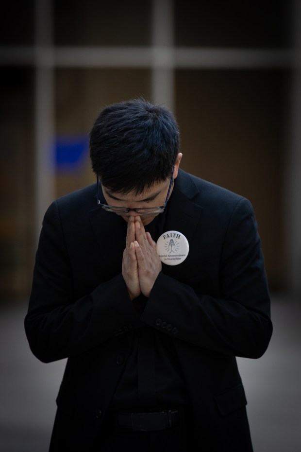 The Rev. Hung Nguyen prays during a City Council meeting where they voted to approve the Due Process and Safety Ordinance Monday. (Ana Ramirez / The San Diego Union-Tribune)