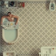 Man in bathtub on a tiled floor