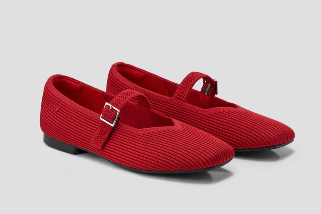 Pair of red knit Mary Jane flats with silver buckles.