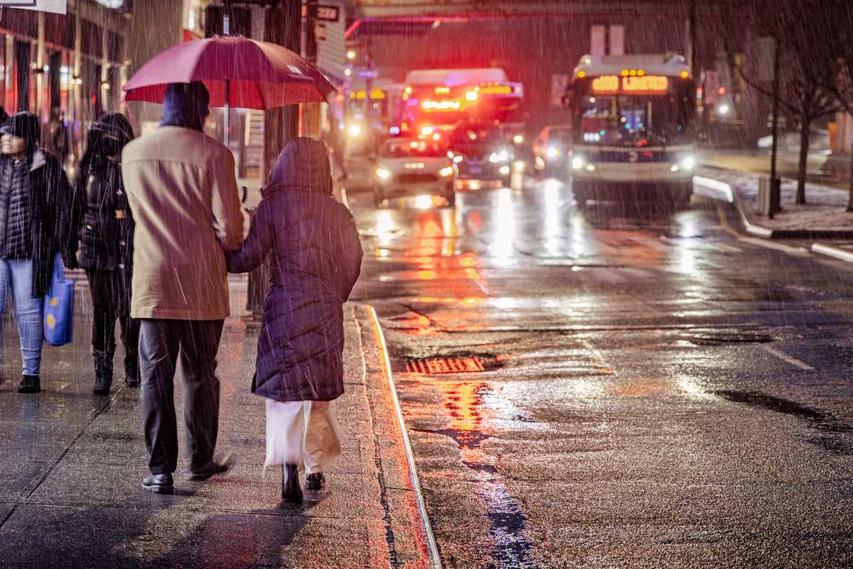 Daylight saving time ends this Sunday. Here's why NYC is stepping up its traffic enforcement as the clocks fall back. 1 people walking on rainy winter street in NYC after daylight savings time ended
