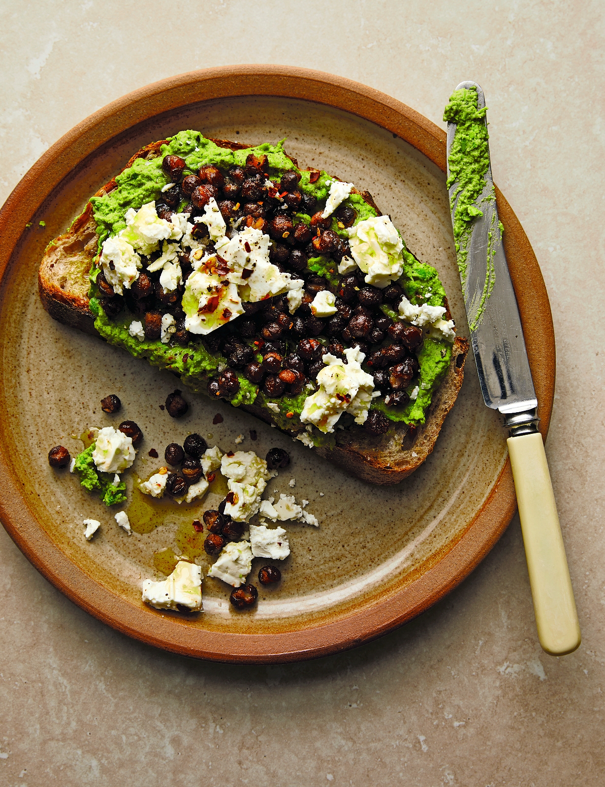 Double pea toasts with pea smash, feta, and crispy carlin peas.