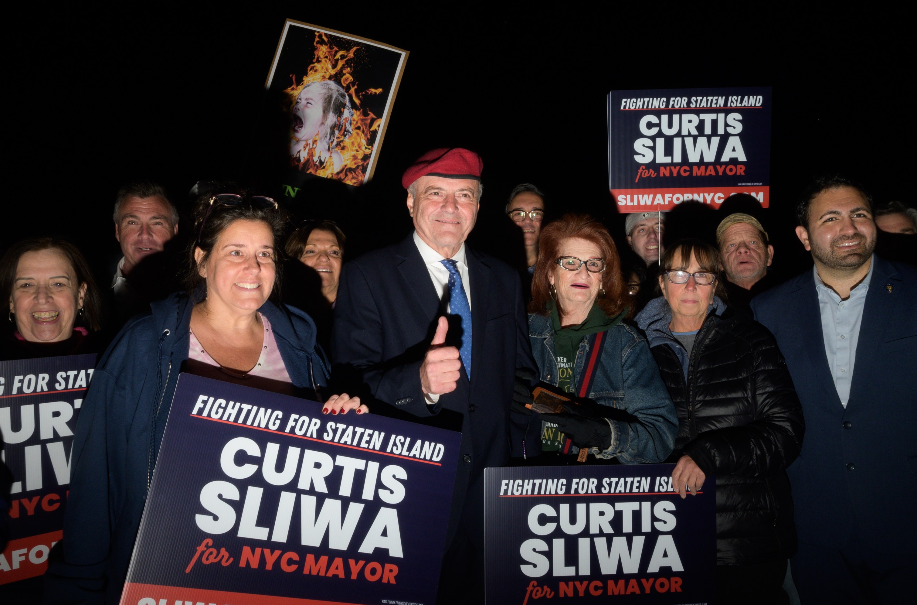 Curtis Sliwa and his fans posing for a photograph during a campaign rally.