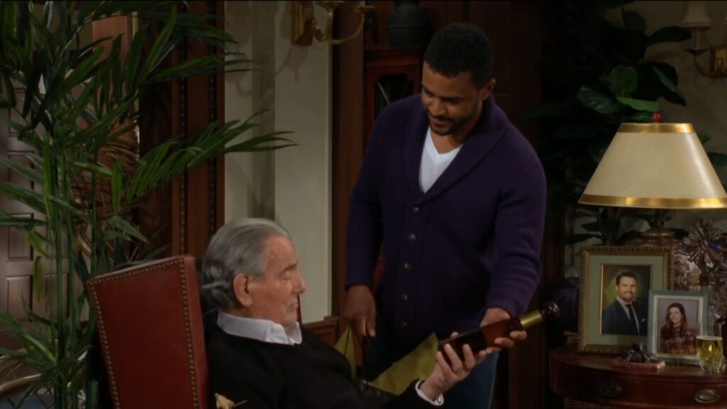 Nate presents Victor with a bottle of tequila.