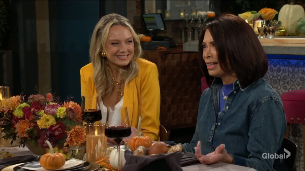 Abby smiles as Amy talks.