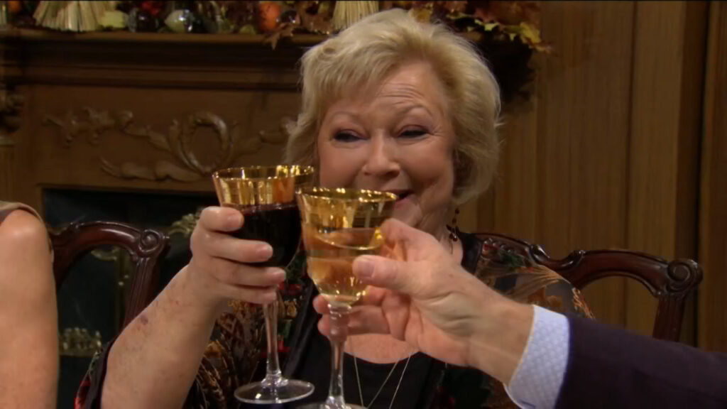 Traci smiles as she toasts.