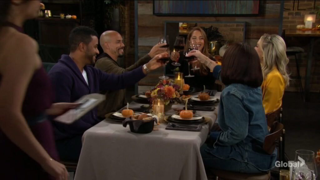Nate, Devon, Lily, Abby, and Amy raise their glasses in a toast.