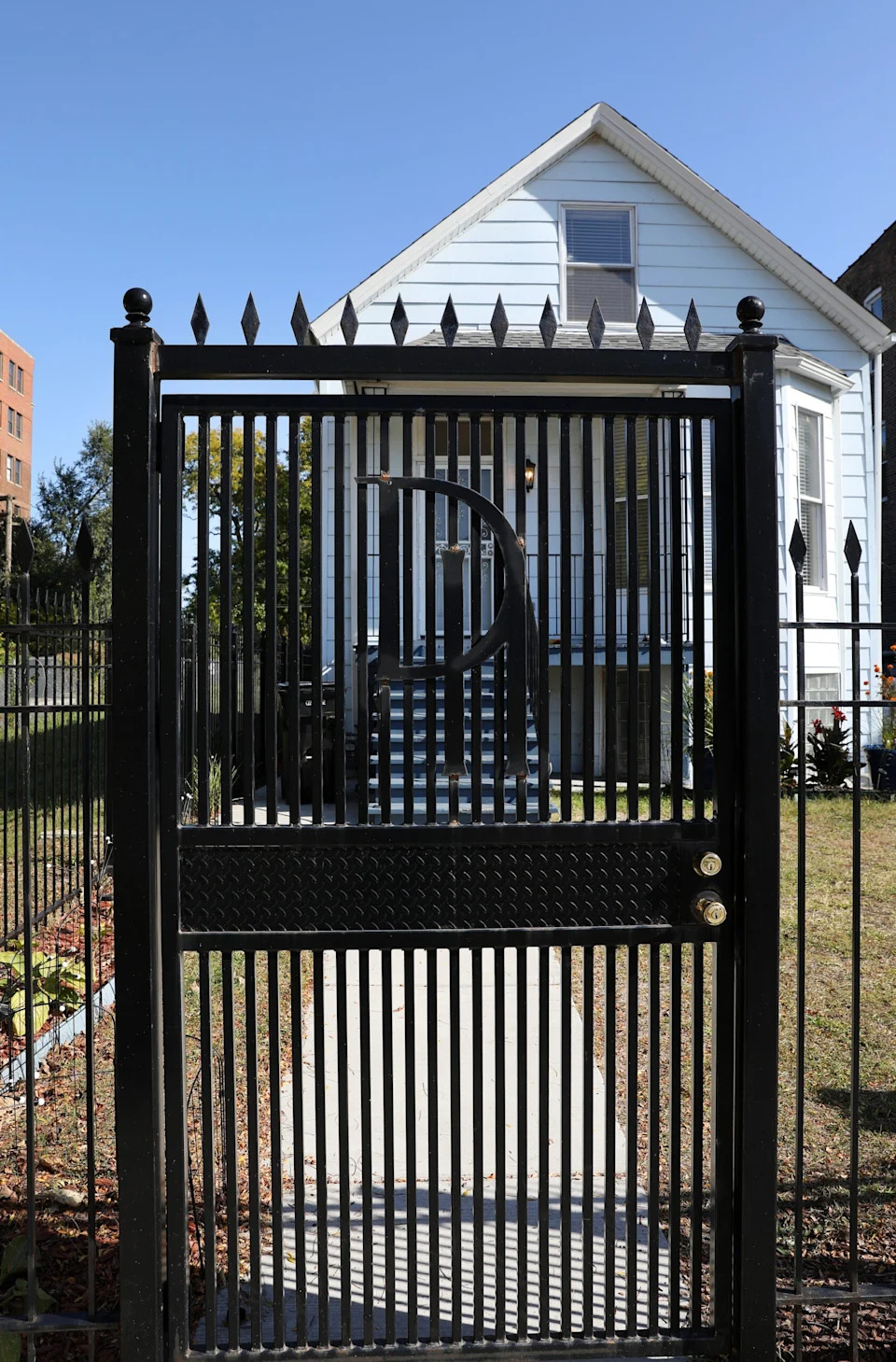 The home is situated behind a iron fence with the letters, "DH," for "Donda's House," on it. <span class="image-credit">(Raymond Boyd/Getty Images)</span>