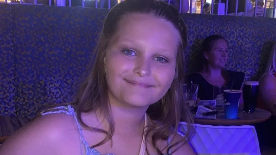 A handout of Mia Lucas smiling with her hair tied back wearing a summery top.