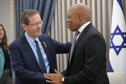 Issac Herzog, left, shakes Eric Adams' hand, Jerusalem, Monday.