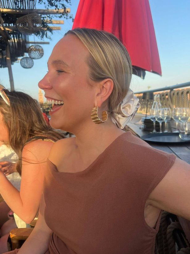 Picture showing Lily with a clear complexion as she sits in the sunshine laughing