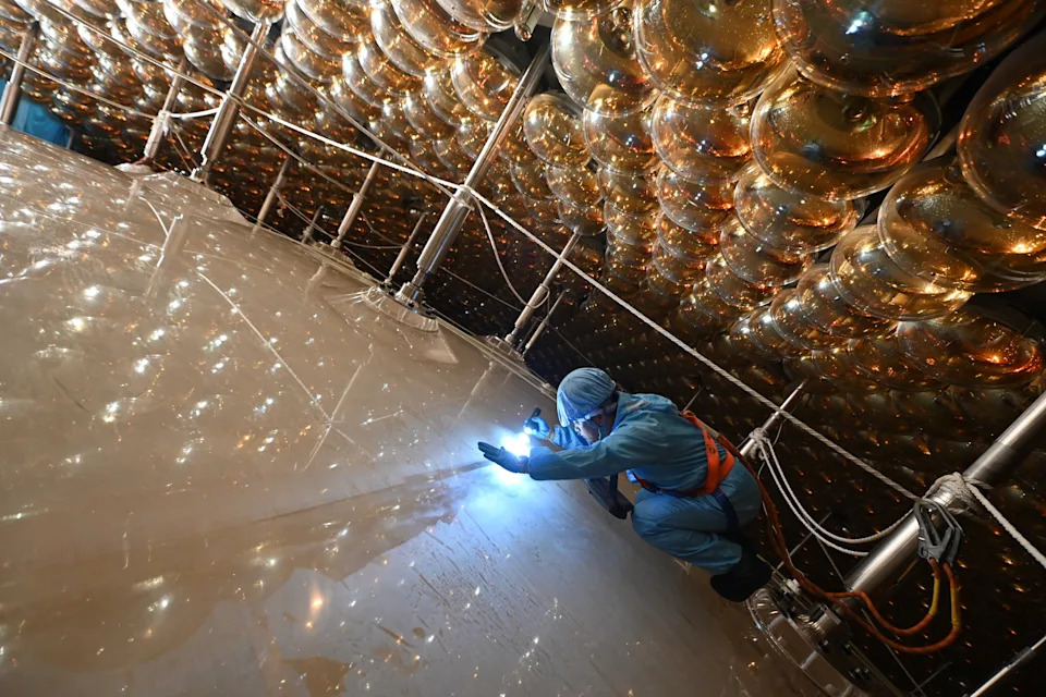 Final preparations for JUNO. Inside the white sphere is 20,000 tons of liquid which, when struck by a neutrino, produces a flash of light that is picked up by sensors surrounding the sphere.