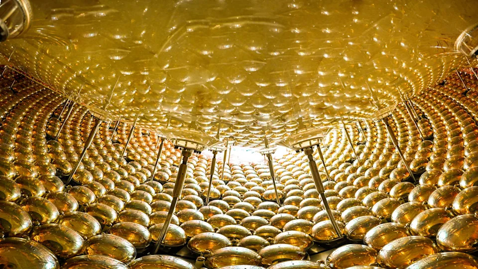 The JUNO detector contains 20,000 tons of liquid in a central sphere. When struck by a neutrino, the liquid produces a flash of light that is picked up by the array of sensors surrounding the sphere.