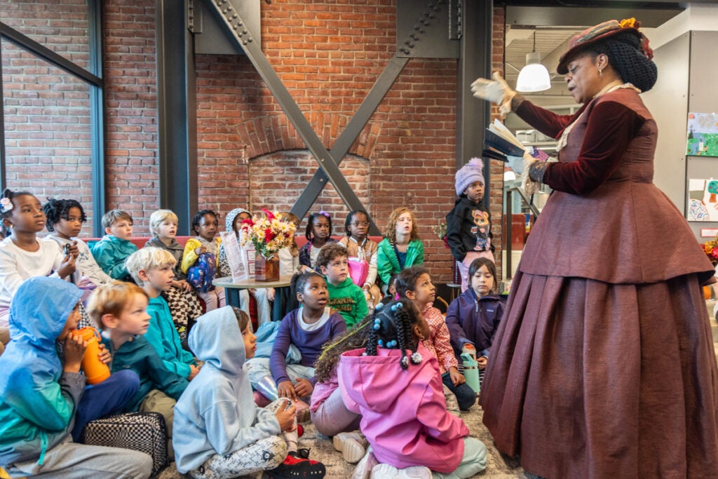 Sharia Benn talking to youth about activist Francis Harper