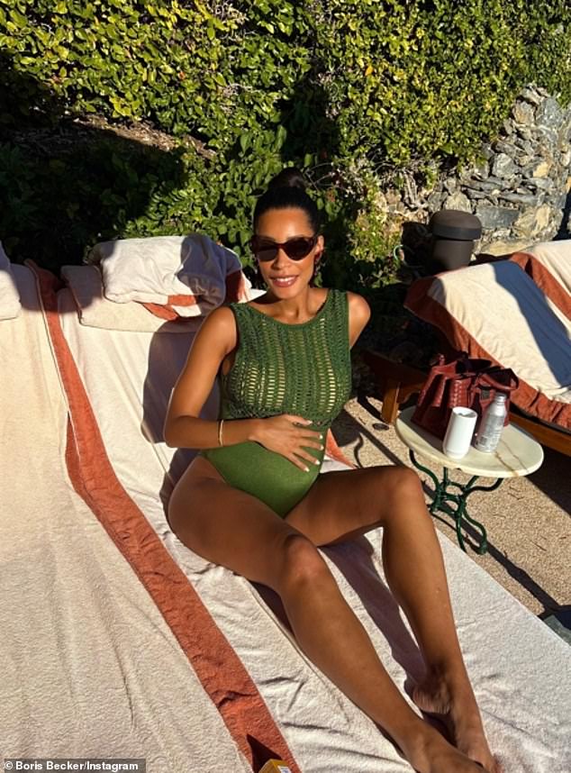 Lilian displayed her baby bump as she sunbathed in a dark green high-neck swimsuit, which featured a sheer crochet top section